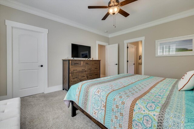 carpeted bedroom featuring ceiling fan and crown molding