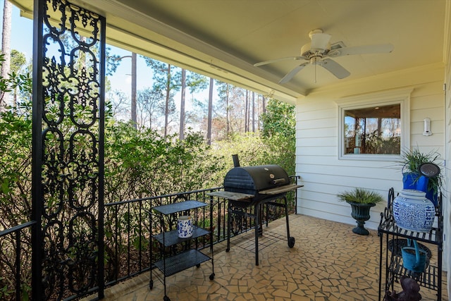 view of patio featuring area for grilling and a ceiling fan