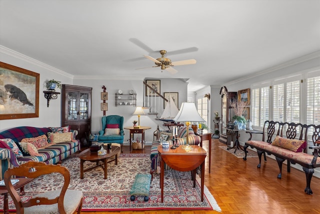 living room featuring ceiling fan, stairway, and ornamental molding