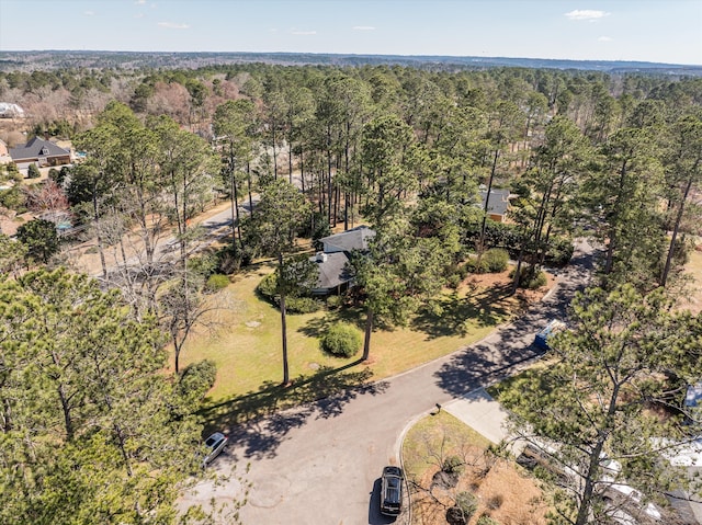 birds eye view of property with a wooded view