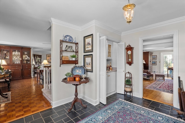 entrance foyer featuring a chandelier, parquet flooring, baseboards, and ornamental molding