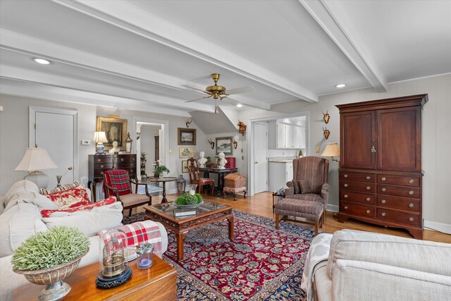 living area with beamed ceiling, recessed lighting, light wood-type flooring, and ceiling fan