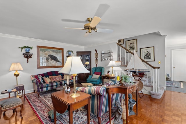 living area featuring stairway, baseboards, ceiling fan, and ornamental molding