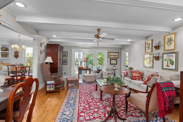 living area featuring beam ceiling, light wood-style floors, and a wealth of natural light