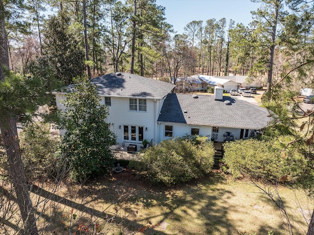 back of property featuring a shingled roof