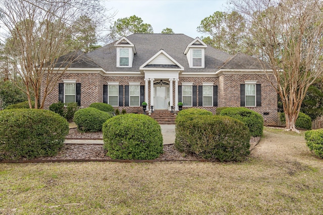 new england style home featuring a front yard