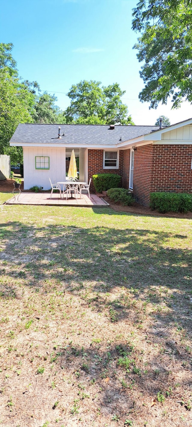 view of front facade with a patio area and brick siding