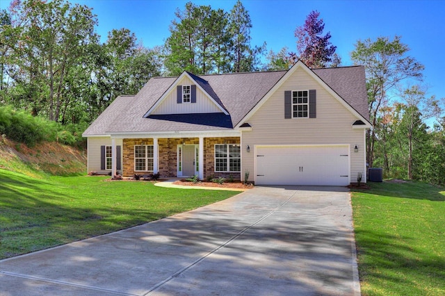 view of front facade with central AC, a garage, and a front lawn