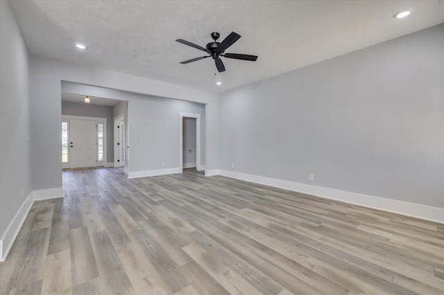 spare room with light hardwood / wood-style flooring and ceiling fan