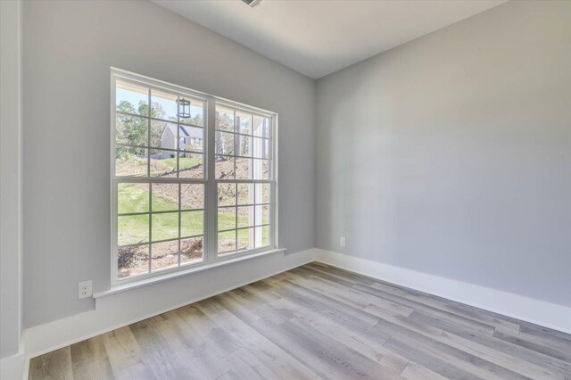 unfurnished room with light hardwood / wood-style floors