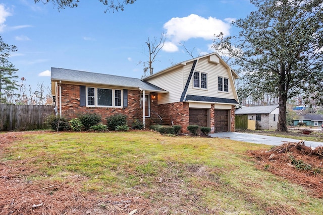 tri-level home with a garage and a front lawn