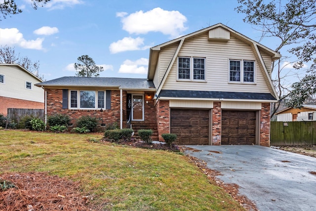 split level home featuring a front yard and a garage