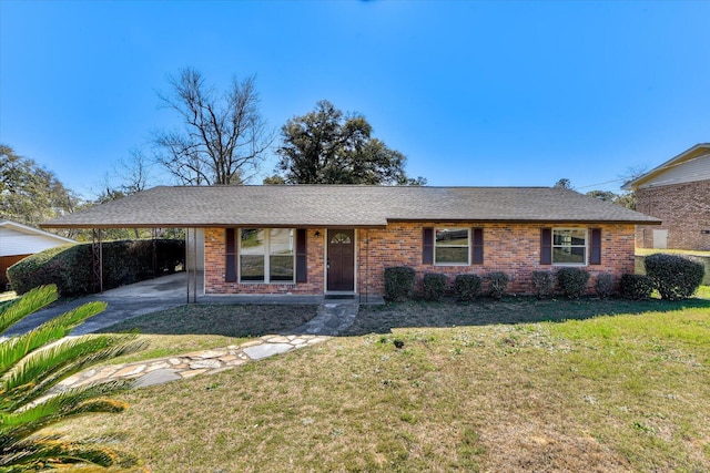 ranch-style house with a carport, a front yard, brick siding, and roof with shingles