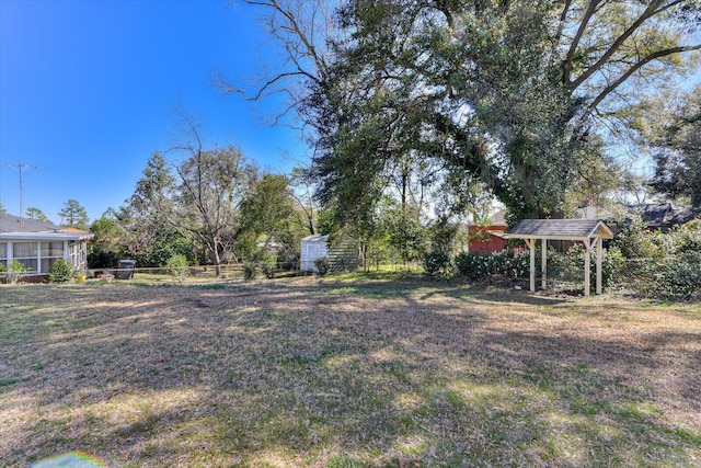 view of yard featuring a sunroom and fence