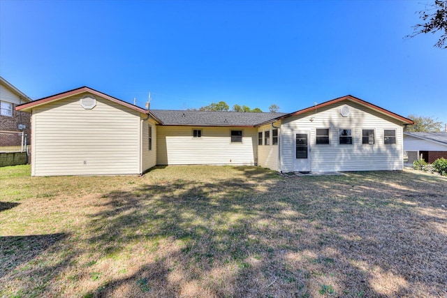 back of property featuring a yard