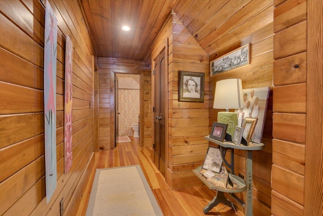 corridor featuring recessed lighting, wood finished floors, wood ceiling, and wooden walls