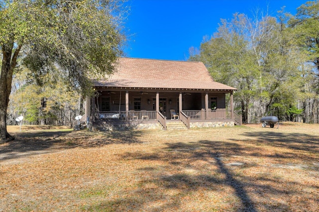 view of front of property featuring a porch and roof with shingles