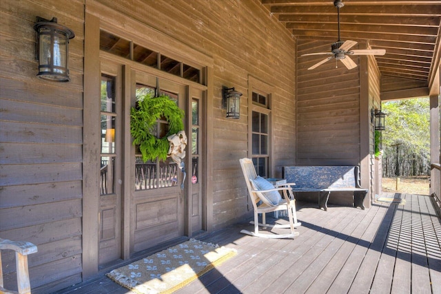 wooden terrace featuring a porch and ceiling fan