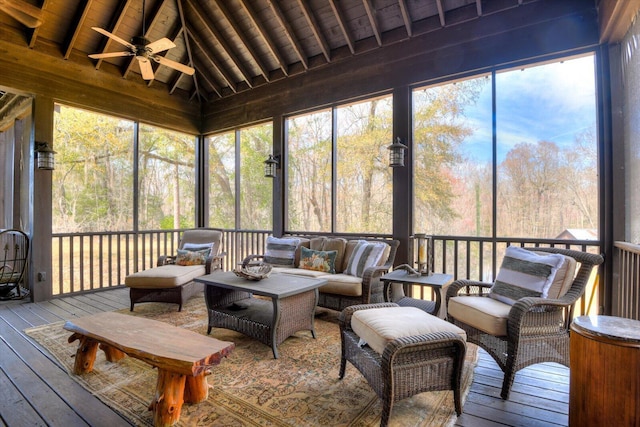 sunroom with vaulted ceiling with beams, wood ceiling, and ceiling fan