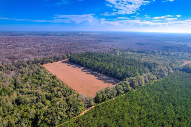 drone / aerial view featuring a forest view