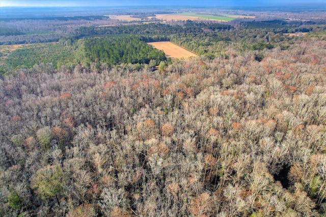 bird's eye view with a wooded view