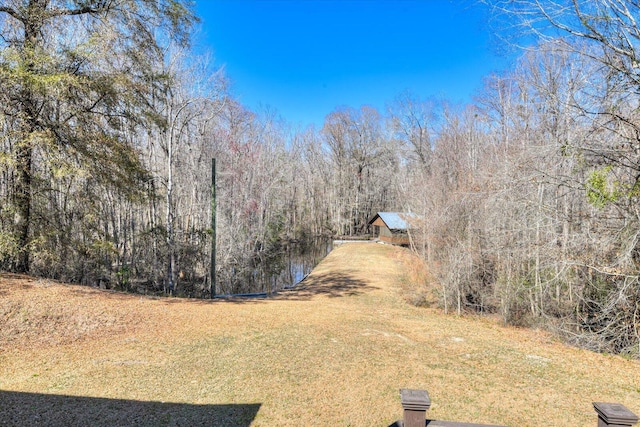 view of yard featuring a forest view