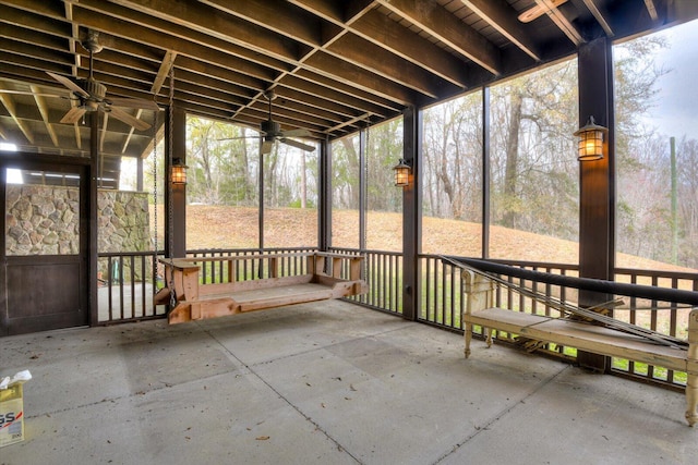 unfurnished sunroom featuring a ceiling fan