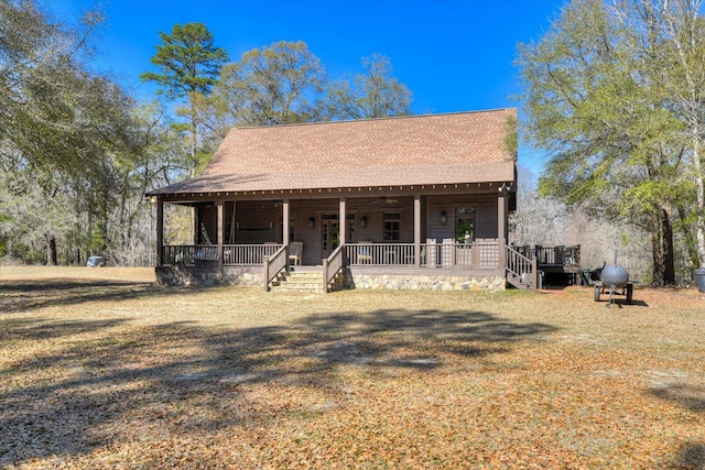 view of front of home featuring covered porch, ceiling fan, and a shingled roof