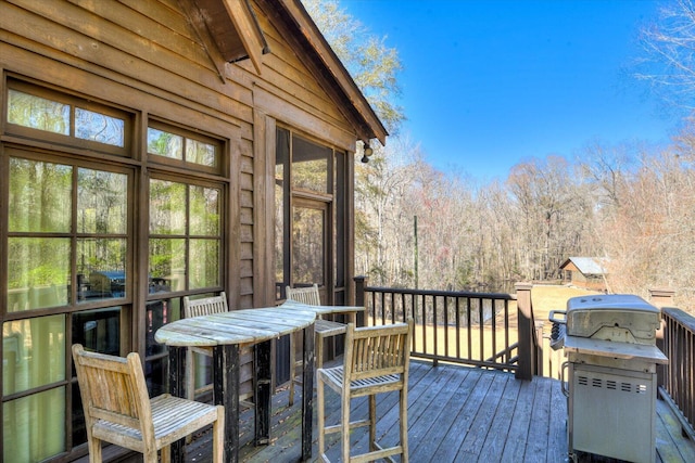 wooden terrace featuring a grill