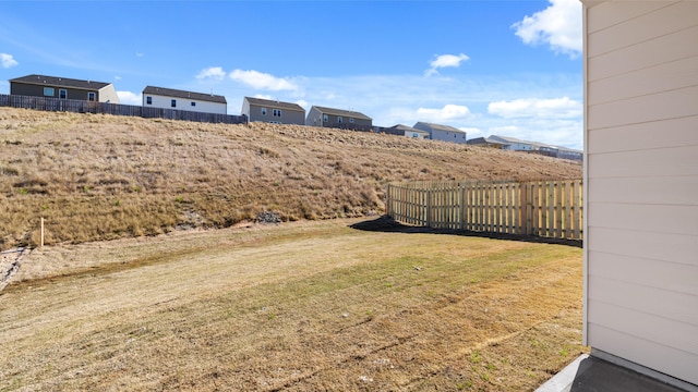 view of yard with fence and a residential view