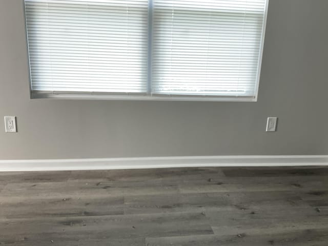 spare room with dark wood-type flooring