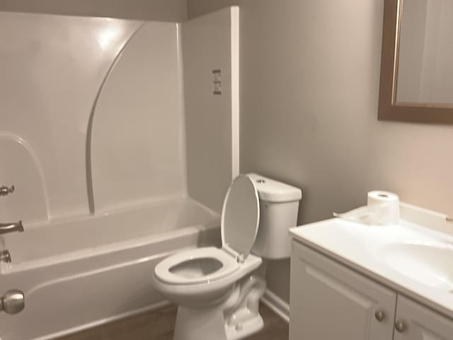 full bathroom with vanity, tub / shower combination, and toilet