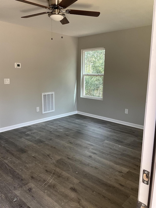 spare room with ceiling fan and dark hardwood / wood-style floors