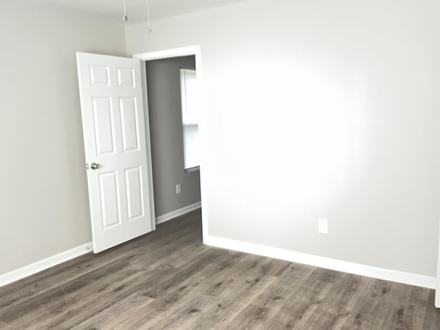 spare room with dark hardwood / wood-style flooring