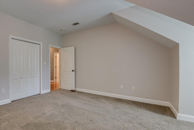 207 Oleander Trl, Evans, GA 30809 - unfurnished bedroom featuring carpet floors, lofted ceiling, and a closet