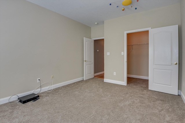 207 Oleander Trl, Evans, GA 30809 - unfurnished bedroom featuring carpet, a walk in closet, and a closet