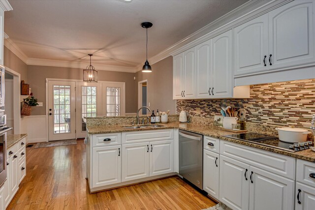207 Oleander Trl, Evans, GA 30809 - kitchen with dishwasher, a peninsula, light wood-style floors, black electric stovetop, and white cabinets