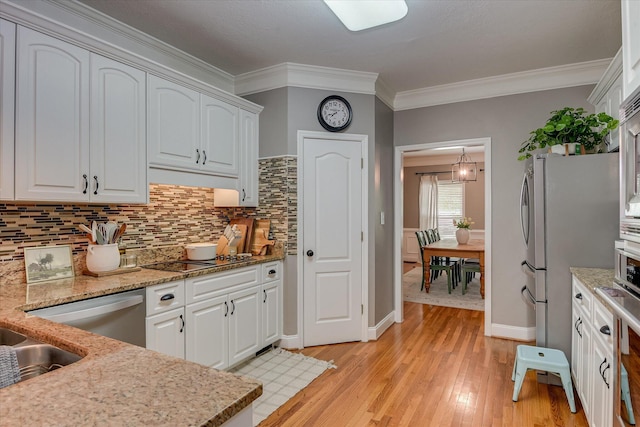 207 Oleander Trl, Evans, GA 30809 - kitchen featuring black electric stovetop, white cabinets, light wood-style flooring, and crown molding