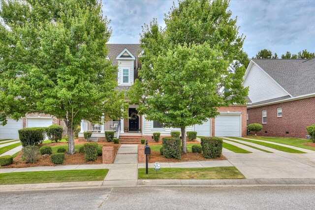 207 Oleander Trl, Evans, GA 30809 - obstructed view of property with driveway, a porch, brick siding, and a garage