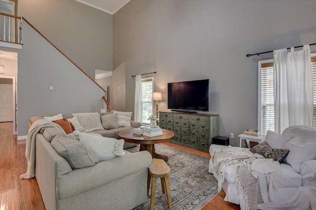 207 Oleander Trl, Evans, GA 30809 - living room featuring stairway, light wood-type flooring, a towering ceiling, and ornamental molding