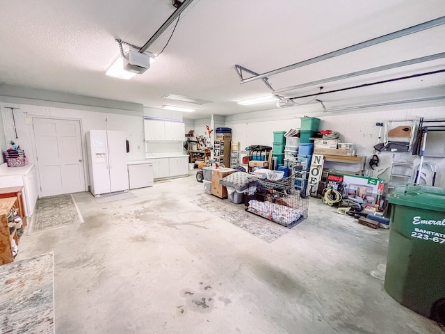 228 Heron Shrs, Mccormick, SC 29835 - garage featuring white refrigerator with ice dispenser and a garage door opener