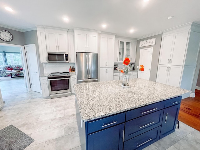 228 Heron Shrs, Mccormick, SC 29835 - kitchen with blue cabinets, white cabinetry, decorative backsplash, and appliances with stainless steel finishes