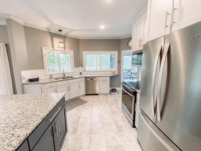 228 Heron Shrs, Mccormick, SC 29835 - kitchen featuring white cabinetry, stainless steel appliances, ornamental molding, a sink, and light stone counters