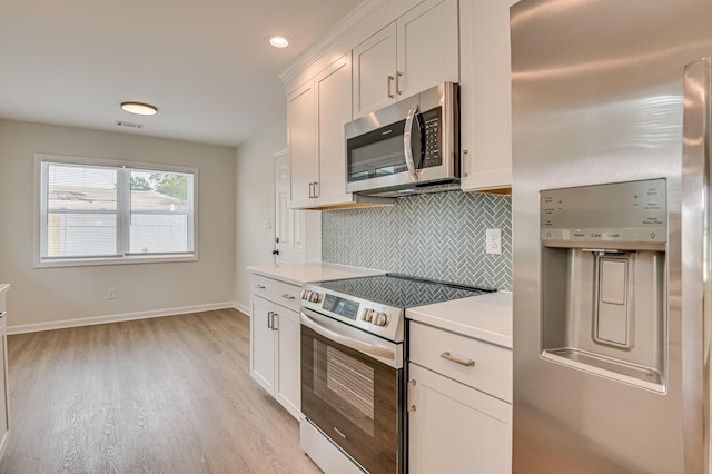 4075 Flintrock Way, Martinez, GA 30907 - kitchen featuring appliances with stainless steel finishes, tasteful backsplash, light countertops, light wood finished floors, and white cabinetry
