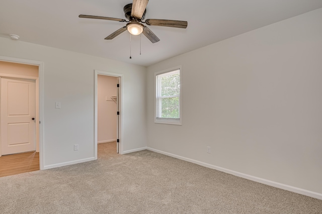 4075 Flintrock Way, Martinez, GA 30907 - unfurnished bedroom featuring light carpet, a spacious closet, a ceiling fan, and a closet