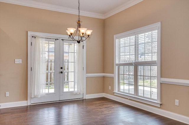 doorway to outside with dark wood-style flooring, baseboards, crown molding, and french doors