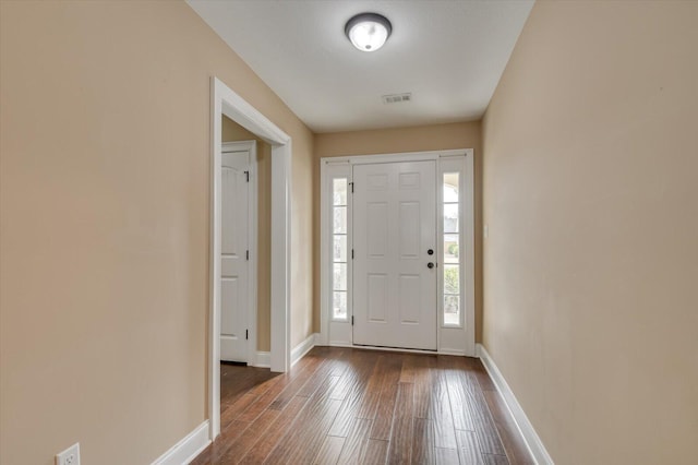 entrance foyer with visible vents, baseboards, and dark wood-type flooring