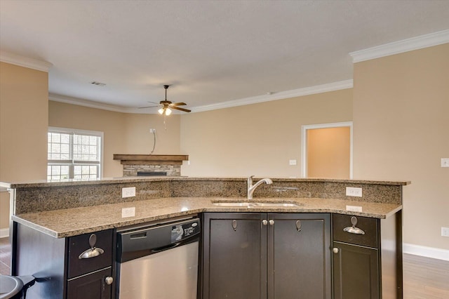 kitchen featuring light stone counters, a sink, visible vents, ornamental molding, and stainless steel dishwasher