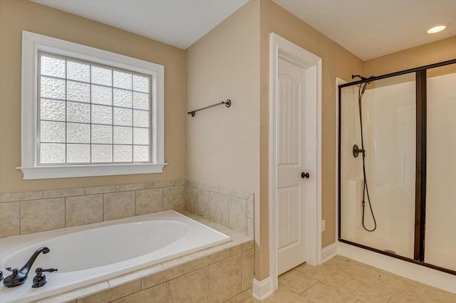 bathroom featuring a bath, a shower stall, a closet, and tile patterned floors