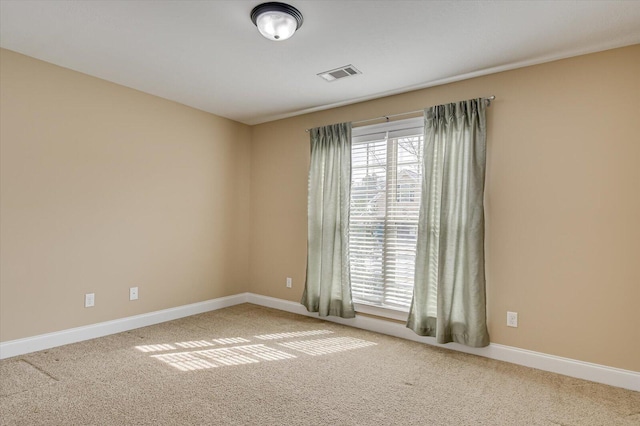 carpeted empty room with a wealth of natural light, visible vents, and baseboards